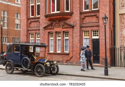 LONDON, UK - JUNE 17, 2013: A Retro Movie Scene With Old-timer Car And Couple On A Street