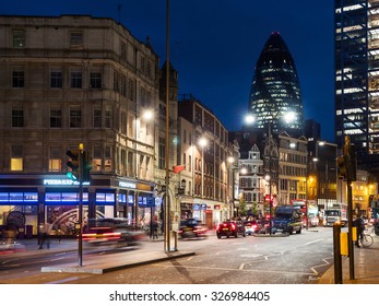 LONDON, UK - JUNE 17, 2015: Traffic And Gherkin Building In The Background At Night. The Gherkin Has Become An Iconic Symbol Of London. 