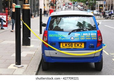 London, UK, June 19, 2011 : Electric car  having its battery recharged at a charging point post in Berkeley Square