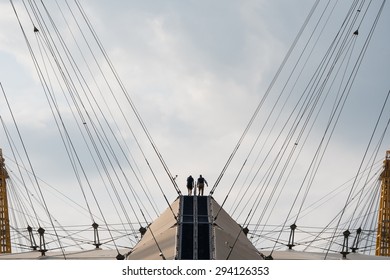 LONDON, UK - JUNE 2015: Climbers on the O2 Arena dome 53 metre (174 feet) high 'Roof Walk', a fabric walkway suspended from masts on August 3, 2013, on the Greenwich Peninsula.