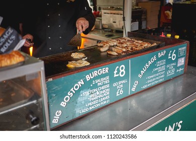 London, UK - June, 2018. Lincolnshire Sausages And Eggs Cooked On A Grill At A Street Food Stall In Borough Market.