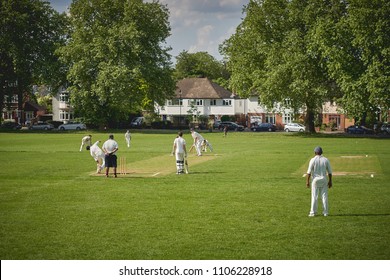 London, UK - June, 2018. People playing cricket in park in South London   