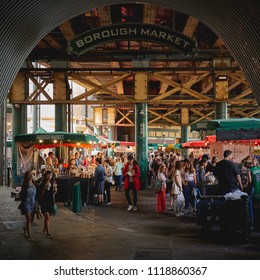 London, UK - June, 2018. Tourists and local eating and shopping in Borough Market, one of the oldest and biggest food market in London.