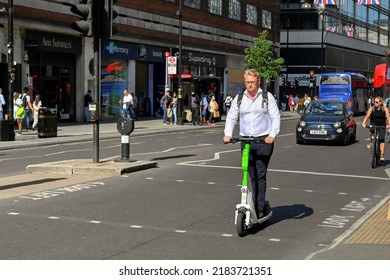 London, UK - June 2022: Person On An Electric Scooter Riding In Front Of Traffic On Oxford Street