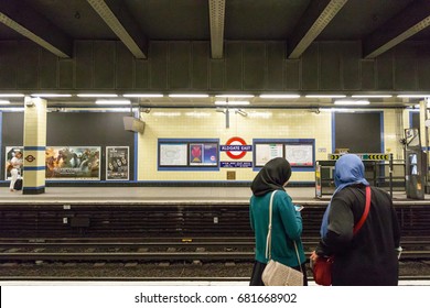 London, UK - June 21, 2017 - Two Muslim Women Waiting On The Platform At Aldgate East Tube Station