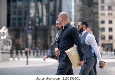 London, UK - June 21, 2022: Group of  business people walking in the City of London street. City of London financial and business area life, street photography