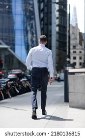 London, UK - June 21, 2022: Businessman is walking in the City of London street. City of London financial and business area life, street photography