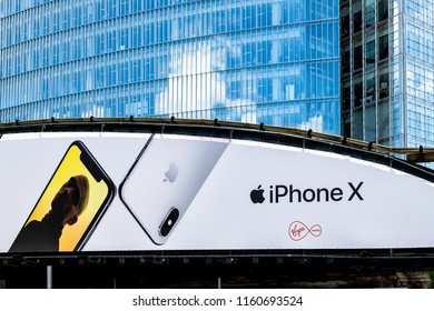 London, UK - June 22, 2018: Advertisement Billboard For IPhone X And Virgin Media On Highway Road Bridge Behind Modern Skyscraper Building