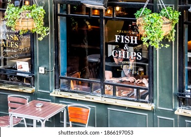 London, UK - June 22, 2018: French fries fish chips restaurant Greene King pub tavern bar restaurant sign on building exterior with people inside sitting eating