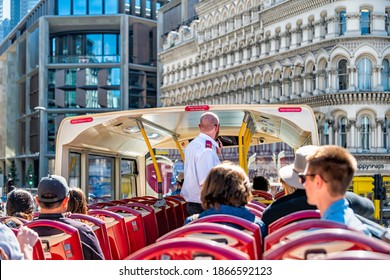 London, UK - June 22, 2018: Downtown city and pov of top of Big Bus double decker with guided tour guide man speaking on microphone and tourists sitting in seats