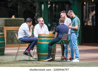 London, UK - June 22, 2022: Group Of Young Professional People  Having A Chat In Park Cafe In The City Of London. Business Life In The City.