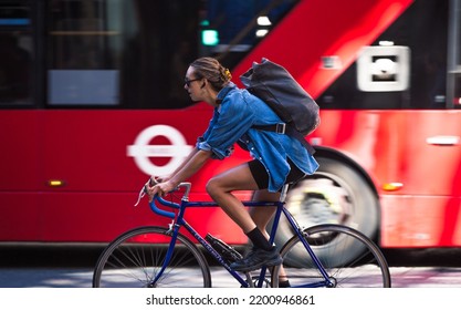 London, UK - June 22, 2022: Young Woman Cycling At Work By Bike. People Cycling Into The City Of London