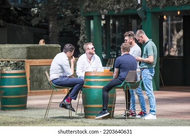 London, UK - June 22, 2022: Group Of Young Professional People  Having A Chat In Park Cafe In The City Of London. Business Life In The City.