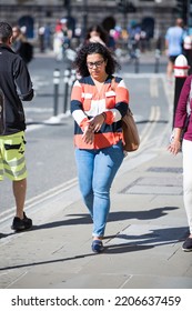 London, UK - June 22, 2022: Young Woman Rush At Work In Early Morning In The City Of London. Business Busy Life Of The City, Street Photography