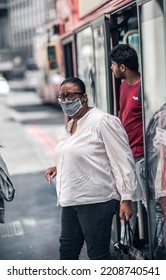 London, UK - June 22, 2022: Woman In Face Mask Gets Out Of The Bus In The City Of London