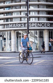 London, UK - June 22, 2022: Young Woman Cycling At Work By Bike. People Cycling Into The City Of London