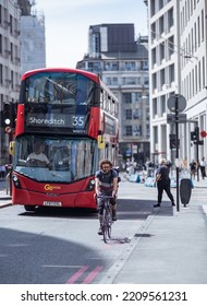 London, UK - June 22, 2022: Young Woman Cycling At Work By Bike. People Cycling Into The City Of London