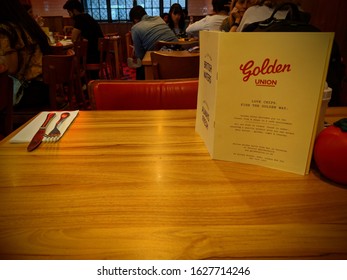 London, UK - June 23 2018: Image Taken Of The Inside Of Golden Union Fish & Chips Shop From The Eating In Area. Seated At An Empty Table With The Menu. Based On Poland Street Off Oxford Circus 