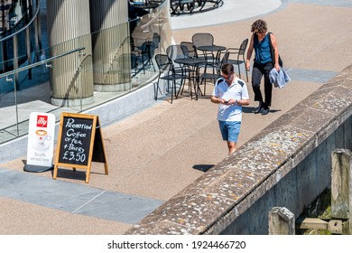 London, UK - June 25, 2018: High Angle View Of People Walking On Sidewalk In Downtown By Illy Cafe Sign Placard For Coffee