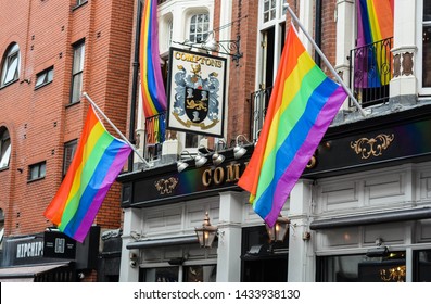 London, UK, June 25, 2019: The Exterior Of Comptons, Soho's Most Famous Gay Bar. LGBT Rainbow Flags Hanging From The Building. 