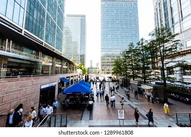 London, UK - June 26, 2018: People Crowd Commuters Outside During Morning Commute Rush Hour In Canary Wharf Docklands With Modern Architecture Clocks Time