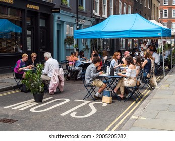 London, UK, June 26th 2021: Outdoor Dining And Eating, Lexington St, Carnaby, London W1F 9AN. Easing Of London Lockdown, Tables, Chairs And Canopy For Customers. Social Distancing.