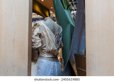 LONDON UK -JUNE 27 2023: Spitalfields Antic Market. Display. An old rag mannequin in an openwork shirt, viewed from the back. - Powered by Shutterstock