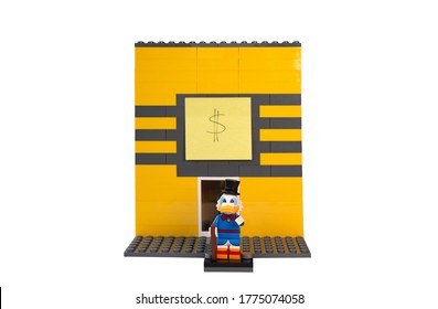 London, UK, June 27th 2020: An Improvised Lego Structure Of Uncle Scrooge's Money Bin. Uncle Scrooge Figurine Standing In Front Of The Bin.