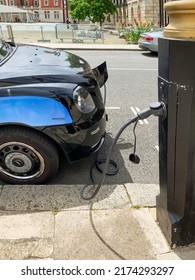 London, UK - June 27th 2022; Front View Of An Electric London Taxi Recharging At A Roadside Charger.