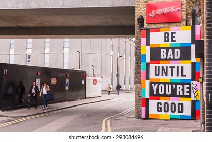 London, UK - June 28 2015: Two Hipster Girls Walking Next To A Big Colored Billboard With The Words 