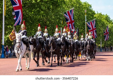 LONDON, UK - JUNE 4, 2015:  Household Cavalry walk along The Mall in London, England, towards Buckingham Palace.  The parade of the Horse Guards is very popular with visitors.