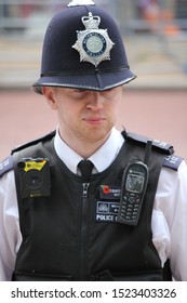 London, UK - June 6th 2019: Police Man Watches Crowd In Helmet And Vest, Also Known As British Bobby- Stock Photo