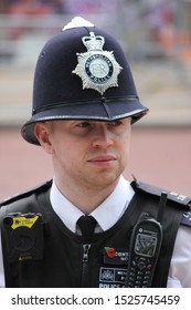 London, UK - June 6th 2019: Police Man Watches Crowd In Helmet And Vest, Also Known As British Bobby- Stock Photo