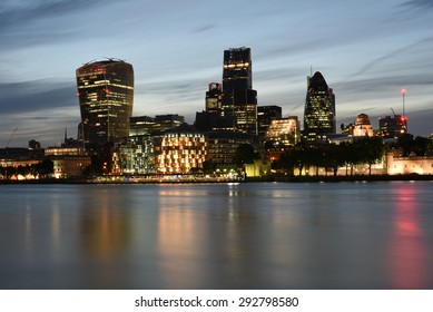 London UK, Majestic Iconic London Skyscrapers 20 Fenchurch Street, Leadenhall, 30 St Mary Axe Or Gherkin Buildings And Other Buildings At  Night On The Bank Of River Thames