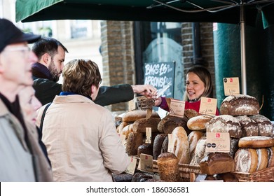 LONDON, UK - MAR 22: Unidentified people purchase bread at a bakery in Borough Market in London on March 22, 2014. 