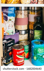 London, UK: March 18, 2020: Cupboard Shelves Fool Of Food Provision, Such As Pasta, Rice, Porridge, Canned Tuna, Beans And More. Panic Buying To Survive Coronavirus COVID 19 Pandemic During Lock Down.