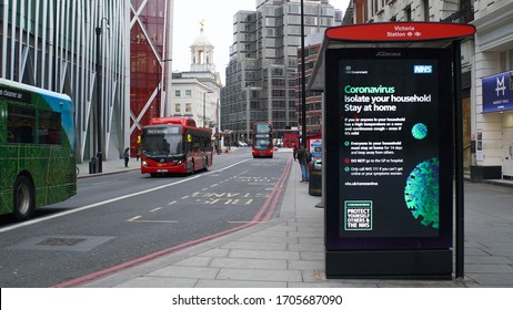 London, UK, March, 20, 2020: Empty Bus Stop Near Victoria Area At London Coronavirus Lockdown. Messege On Led Panel About COVID 19 And Social Distancing