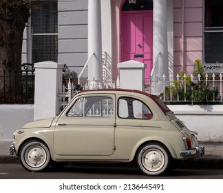 London UK, March 2022. Beige Coloured Vintage Fiat 500 Classic Car Parked In Front Of A House With A Pink Door On A Residential Street In Notting Hill, West London UK.