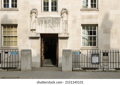 London, UK - March 21, 2022: Royal Academy of Dramatic Art - RADA - on Gower Street, Camden, Central London.  A sculpture over the door shows a contented woman holding the mask of tragedy 