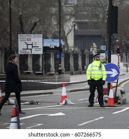 London, UK, March 22, 2017 An Armed Police Officer Stands Guard Near Westminster Bridge And The Houses Of Parliament London. After The Terrorist Attack