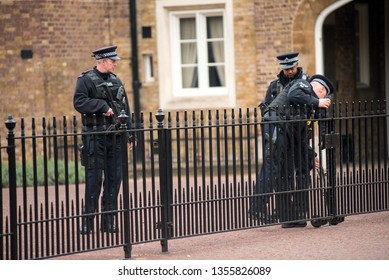 LONDON, UK - MARCH 22, 2019: Armed British Police Officers On Duty Patrolling And Preventing Terrorism Attacks On The Streets Of The City