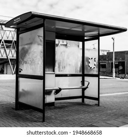 London UK, March 26 2021, Black And White Image Of A Modern Public Bus Stop Shelter Adn Seating With No People