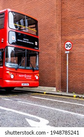 London UK, March 26 2021, Red Double Decker Bus Parked Next To A 30 Mph Road Sign With No People