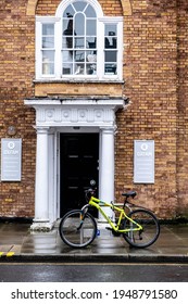 London UK, March 26 2021, Bicycle Parked Outside An Oxfam Charity Shop With No People On A Wet Day