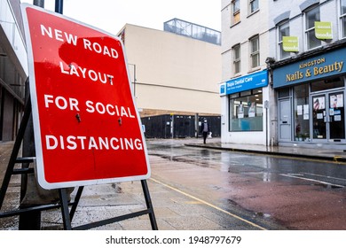 London UK, March 26 2021, Red Road Sign For Social Distancing On An Empty Street With No People On A Wet Raining Day