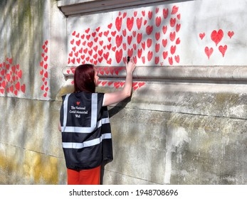 London, UK - March 30, 2021: The National Covid Memorial Wall, Volunteers Painting 150,000 Red Hearts To Commemorate Covid-19 Deaths