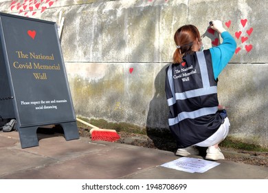 London, UK - March 30, 2021: The National Covid Memorial Wall, Volunteers Painting 150,000 Red Hearts To Commemorate Covid-19 Deaths