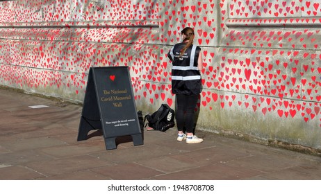 London, UK - March 30, 2021: The National Covid Memorial Wall, Volunteers Painting 150,000 Red Hearts To Commemorate Covid-19 Deaths