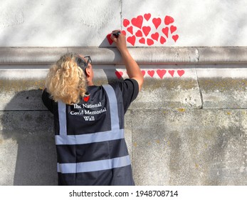 London, UK - March 30, 2021: The National Covid Memorial Wall, Volunteers Painting 150,000 Red Hearts To Commemorate Covid-19 Deaths