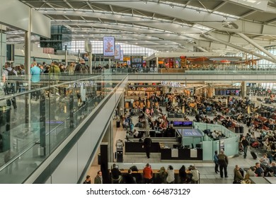 LONDON, UK - MARCH 7 2017: Heathrow Airport, Terminal 5, Passengers Waiting To Get Gate Information, Mid-morning.